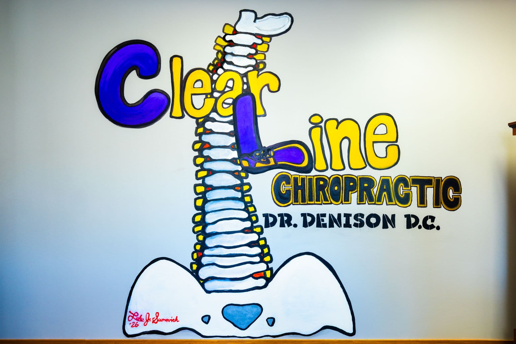 The ClearLine Chiropractic spine mural on the office wall
